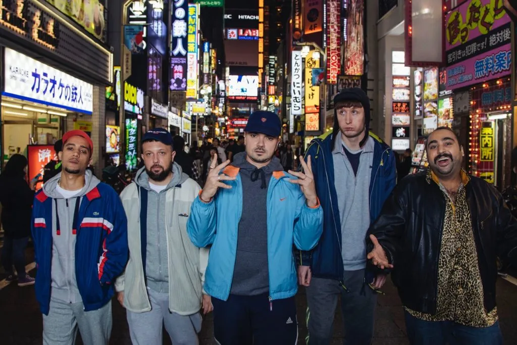 ‘People Just Do Nothing’ Movie Adaptation Shooting In Japan & UK For Focus Features & BBC Films